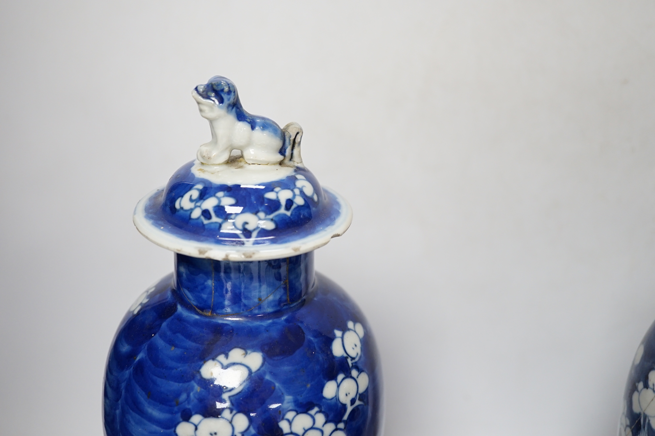 Five early 20th century Chinese blue and white prunus vases and covers, tallest 31cm
